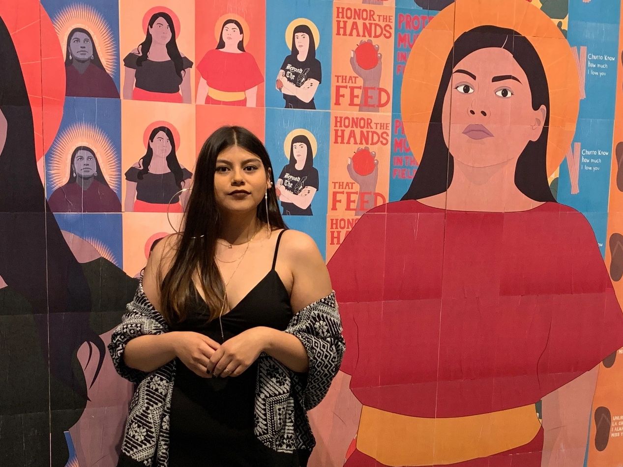 Woman standing next to the artwork.