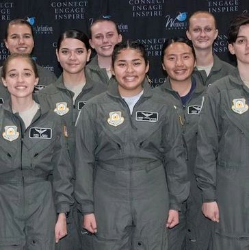 Group of female military aviators posing together at an event.