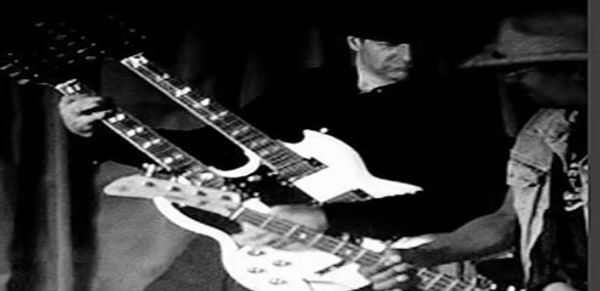 Person with double-neck guitar