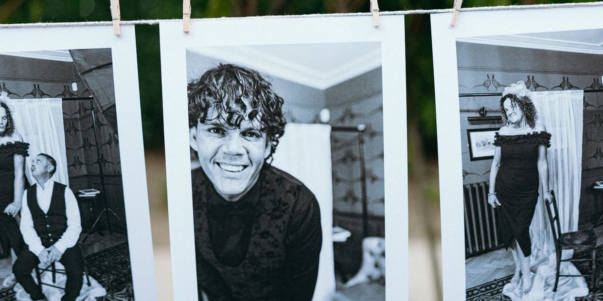 Black and white portraits hanging on a clothesline.