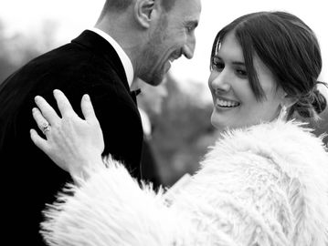 Happy couple smiling and embracing outdoors.