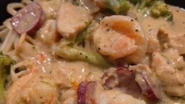 Creamy pasta with shrimp, sausage, and broccoli in a rich sauce.