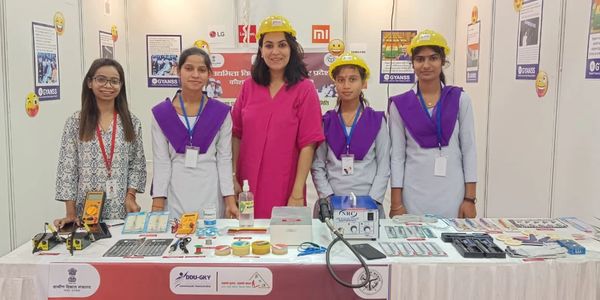 Group of women showcasing electronics at a booth.