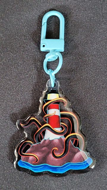 Keychain with a lighthouse and tentacles design.