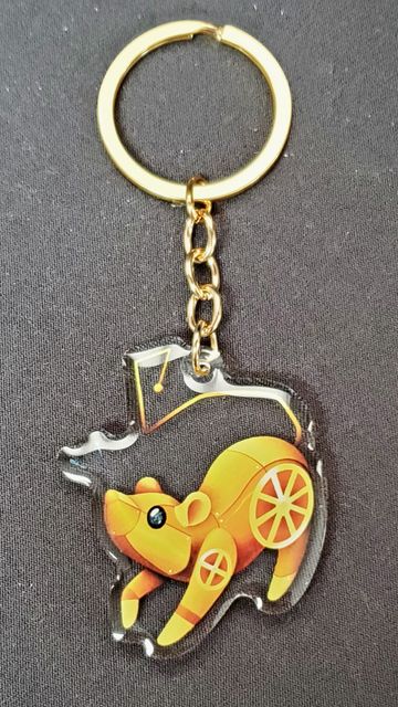 A golden keychain featuring a stylized mechanical bear design.