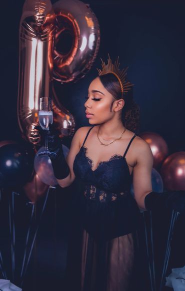 birthday photoshoot portrait with balloons, satin gloves, and crown