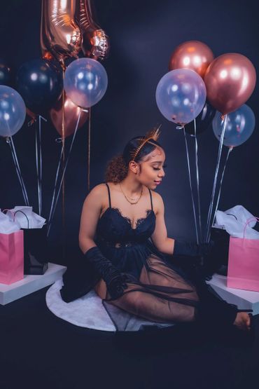 birthday photoshoot portrait with balloons, satin gloves, and crown 