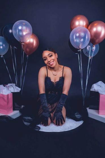 birthday photoshoot portrait with balloons, satin gloves, and crown