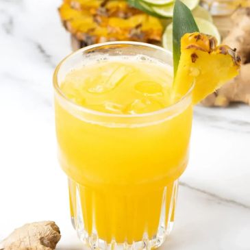 Refreshing pineapple juice garnished with a slice of pineapple.