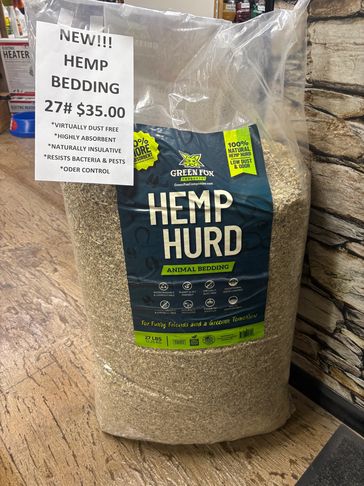 Bag of Green Fox Hemp Hurd animal bedding with price sign.