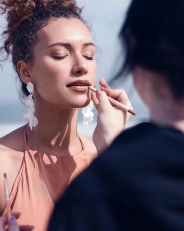 Makeup artist applying lip liner for a special day