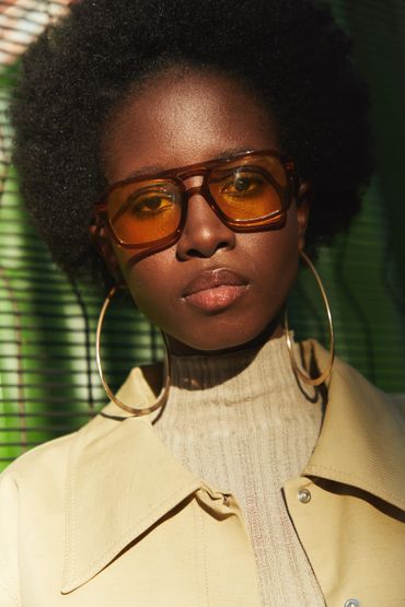 Model posing for a photo wearing natural glowy makeup 