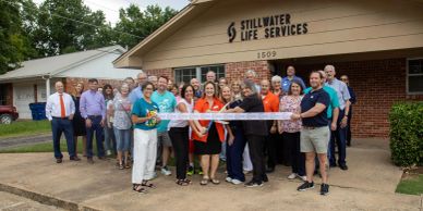 Group cutting ribbon at Stillwater Life Services.