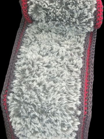 A soft, fluffy gray rug with red and dark gray borders.