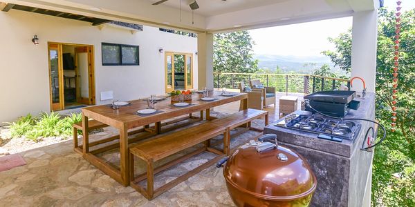 Outdoor kitchen and dining space in the vacation rental.