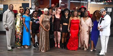 Group of people dressed up and posing indoors.