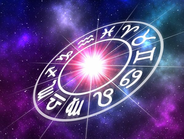 Astrological Wheel with 12 zodiac symbols floating among the stars, a bright light in the center.