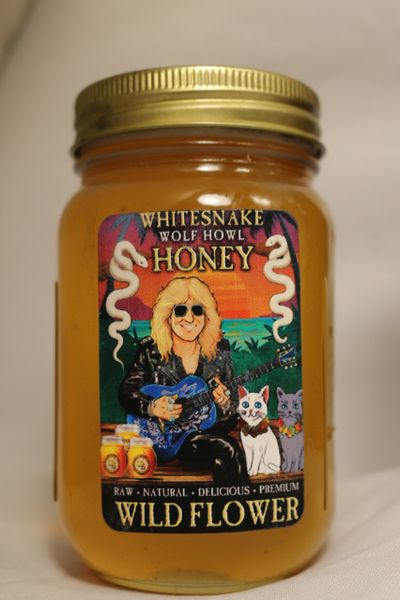 Jar of Whitesnake Wolf Howl Wild Flower honey with colorful label.