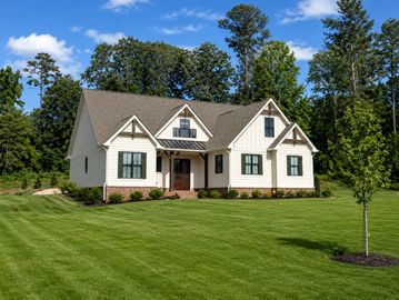 A modern single-story house with a manicured lawn.