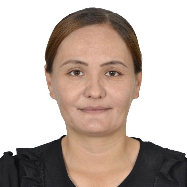 Portrait of a woman with brown hair and a black top against a white background.