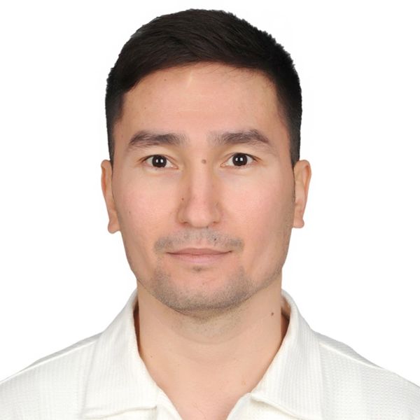 Portrait of a man with short dark hair wearing a white collared shirt.