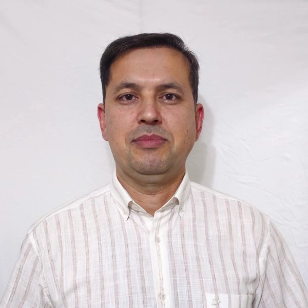 Man in a white striped shirt stands against a plain white background.