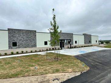 Modern building with stone accents and landscaping.