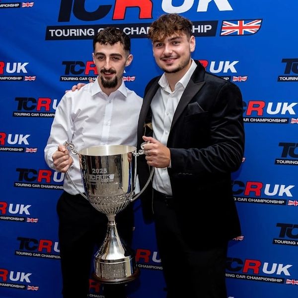 Two men holding a 2025 TCR UK trophy.