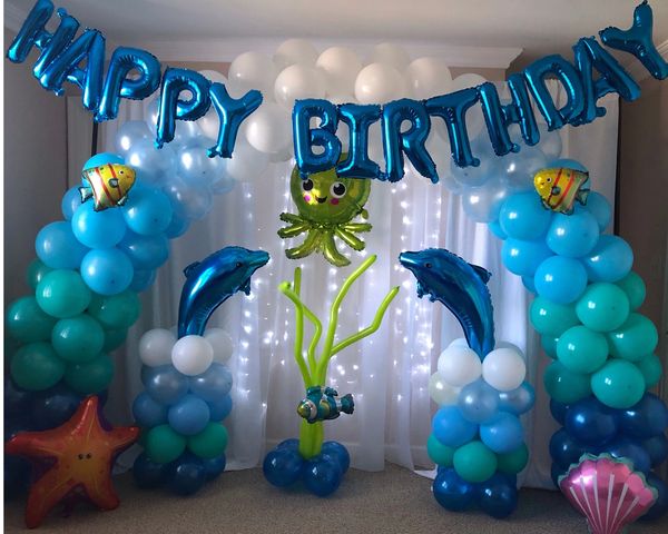 “Under The Sea” arch featuring coordinating mylar balloons and sheer backdrop curtain with lights!