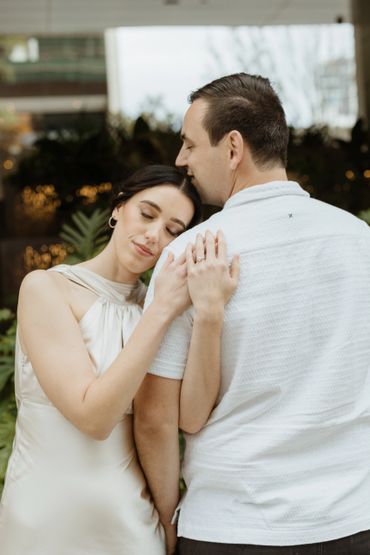 Woman resting her head on a man's shoulder in a tender moment.