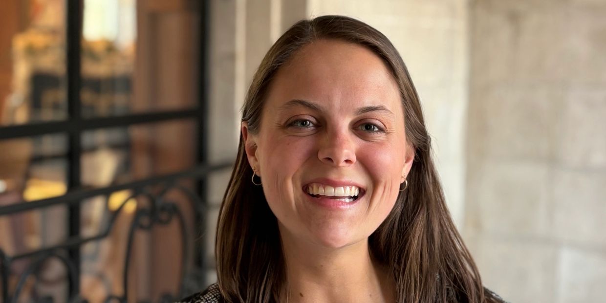 Smiling woman with long brown hair.