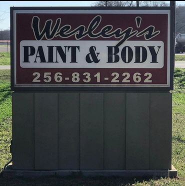 Wesley's Paint &amp; Body sign with contact number.