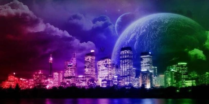City skyline with colorful lighting and a large planet in the sky.