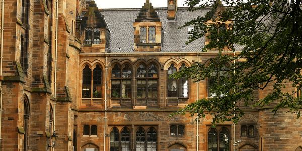 Historic Gothic-style building with arched windows and intricate stonework.
