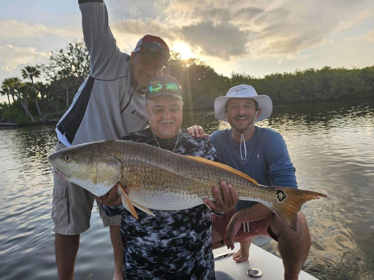 Inshore Fishing Charters are the best during winter months client with a redfish 
