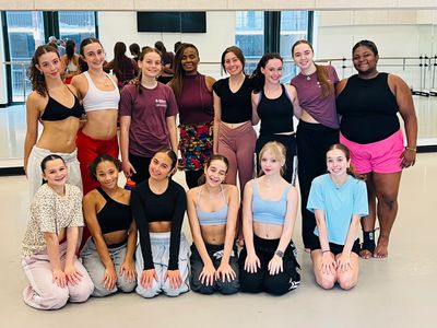 Group of diverse young dancers posing in a dance studio.