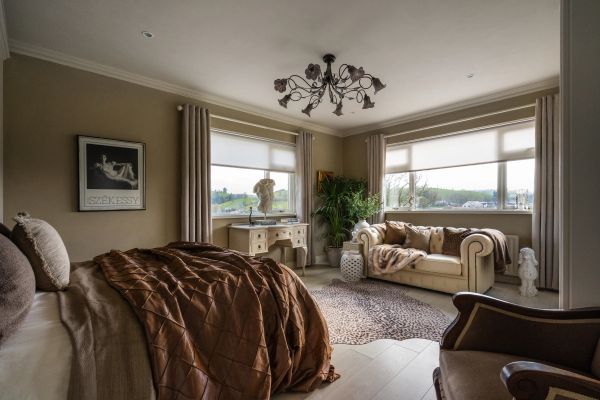 Cozy bedroom with large windows and elegant decor.