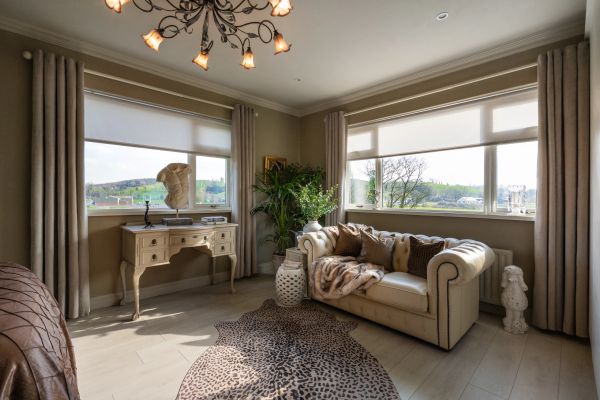 Cozy contemporary living room with large windows and stylish decor.