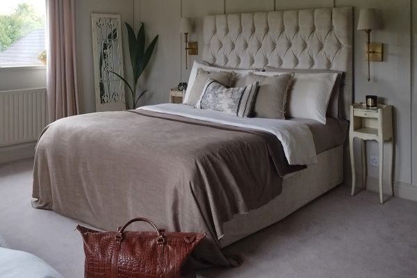 Cozy bedroom with neutral tones and elegant decor.