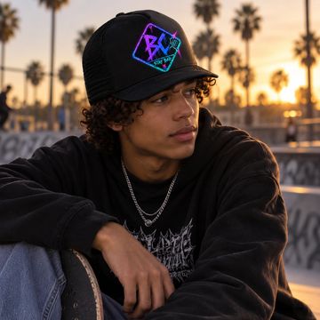 Young man with skateboard at sunset.