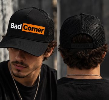Black mesh cap with 'Bad Corner' text worn by a man.