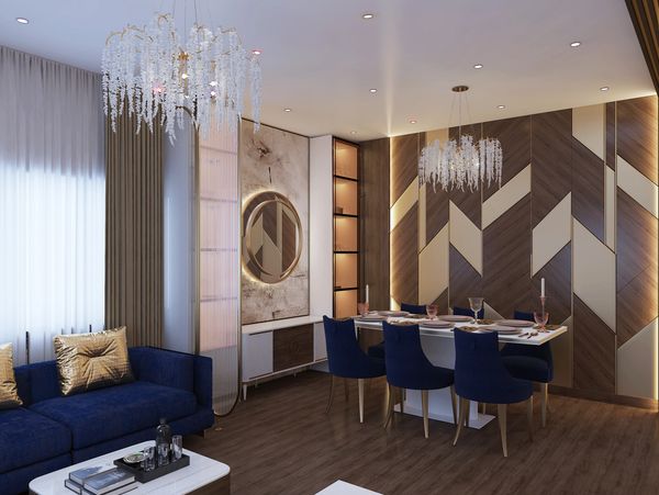 Modern dining and living area with blue chairs and sofa, wood accents, and elegant chandeliers.