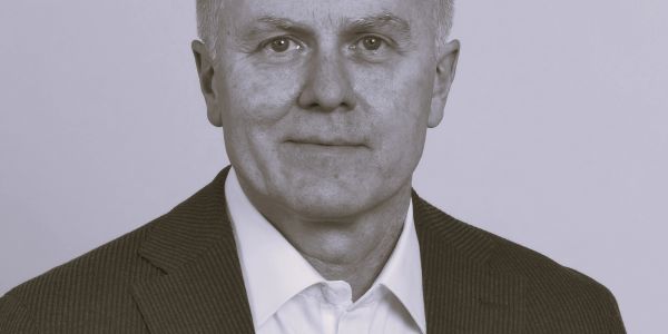 Portrait of a mature man in a business suit with a neutral expression.