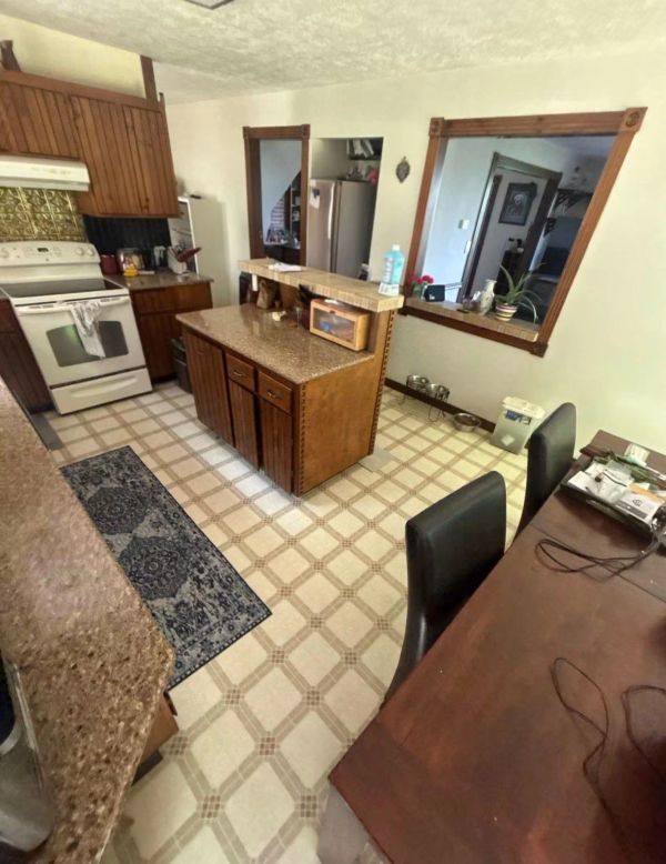 Cozy kitchen with wooden cabinets and a small island.