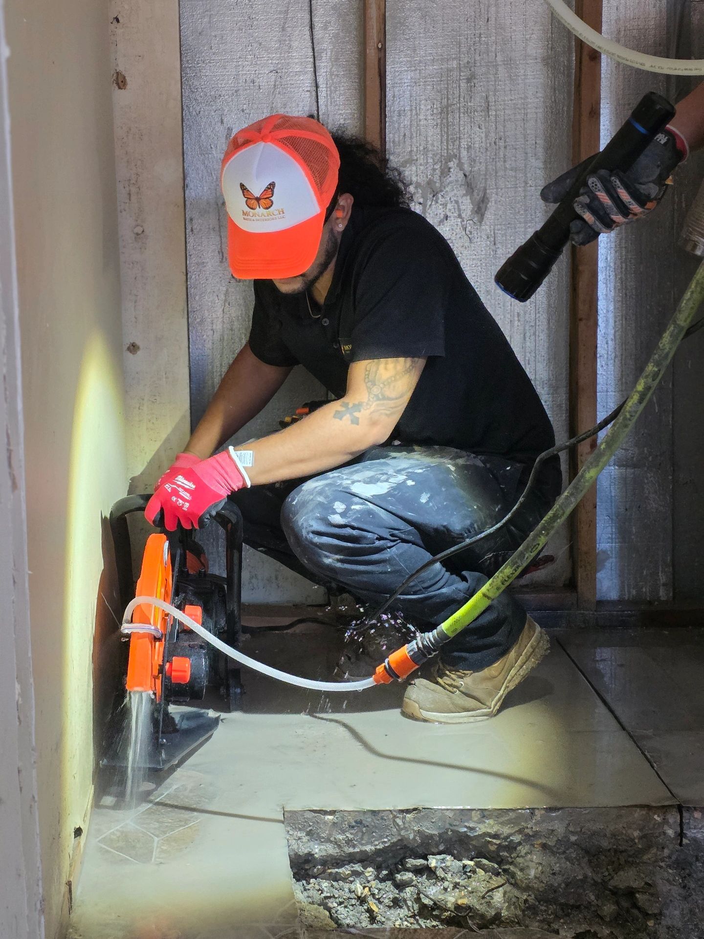 Worker using a saw for cutting concrete floor.