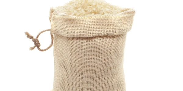 A burlap sack filled with white rice.