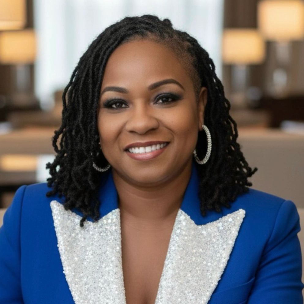 Smiling woman in a blue blazer with sequined lapels.
