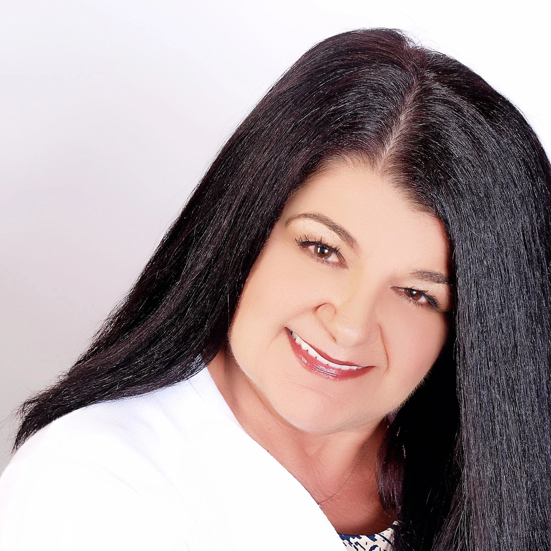 Smiling woman with long black hair.