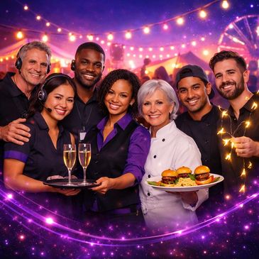 Smiling diverse restaurant staff at a festive outdoor event with food and drinks.