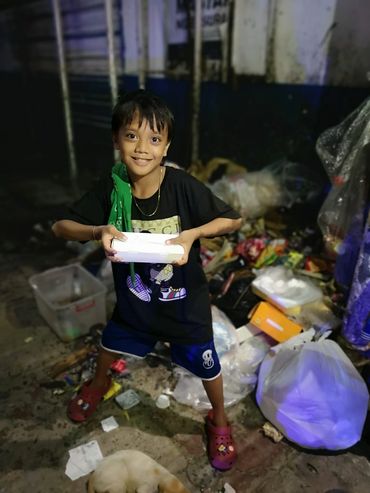 Providing food for the homeless living on the street in Manila, Philippines.